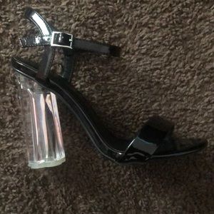 Black heels with a flower print bottom. 7 1/2